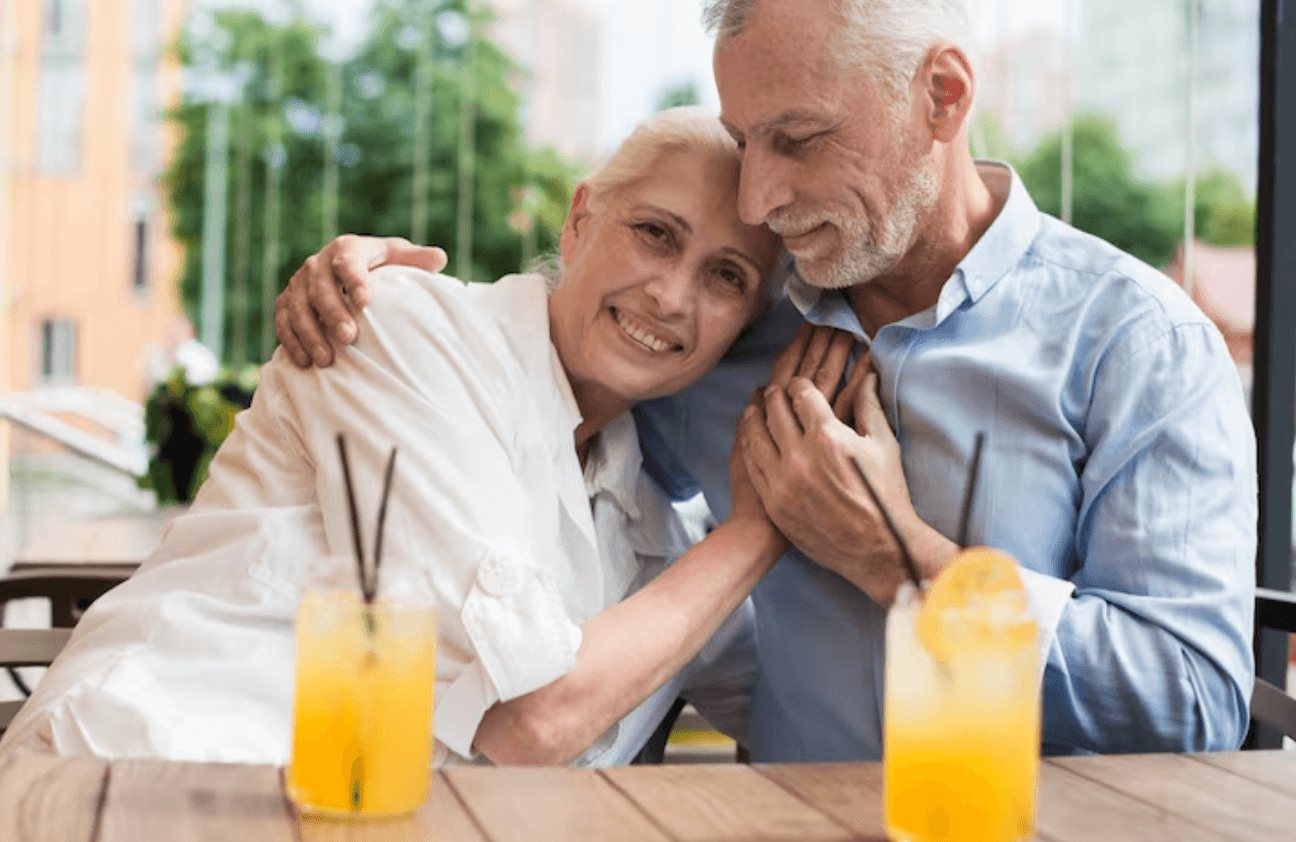 Older couple sharing a drink in a bright setting