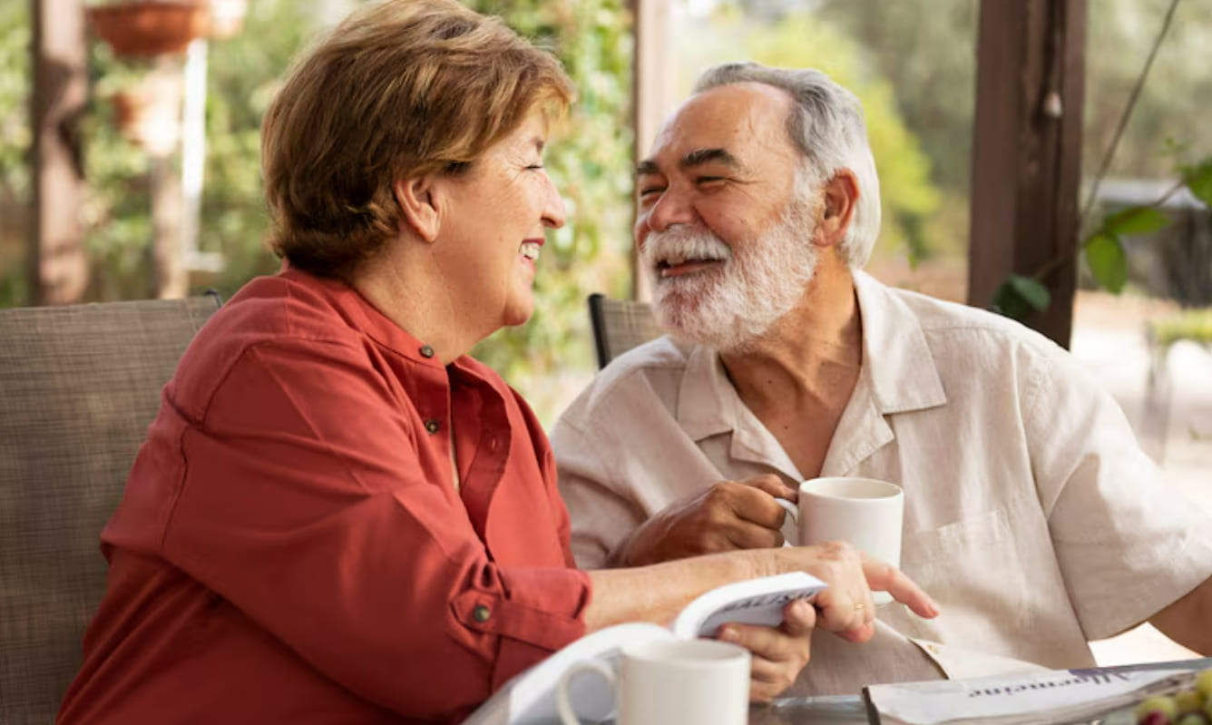 Senior couple talking over coffee on a patio