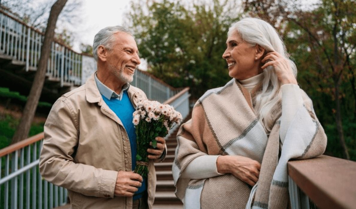 Senior couple enjoying a warm first date style moment
